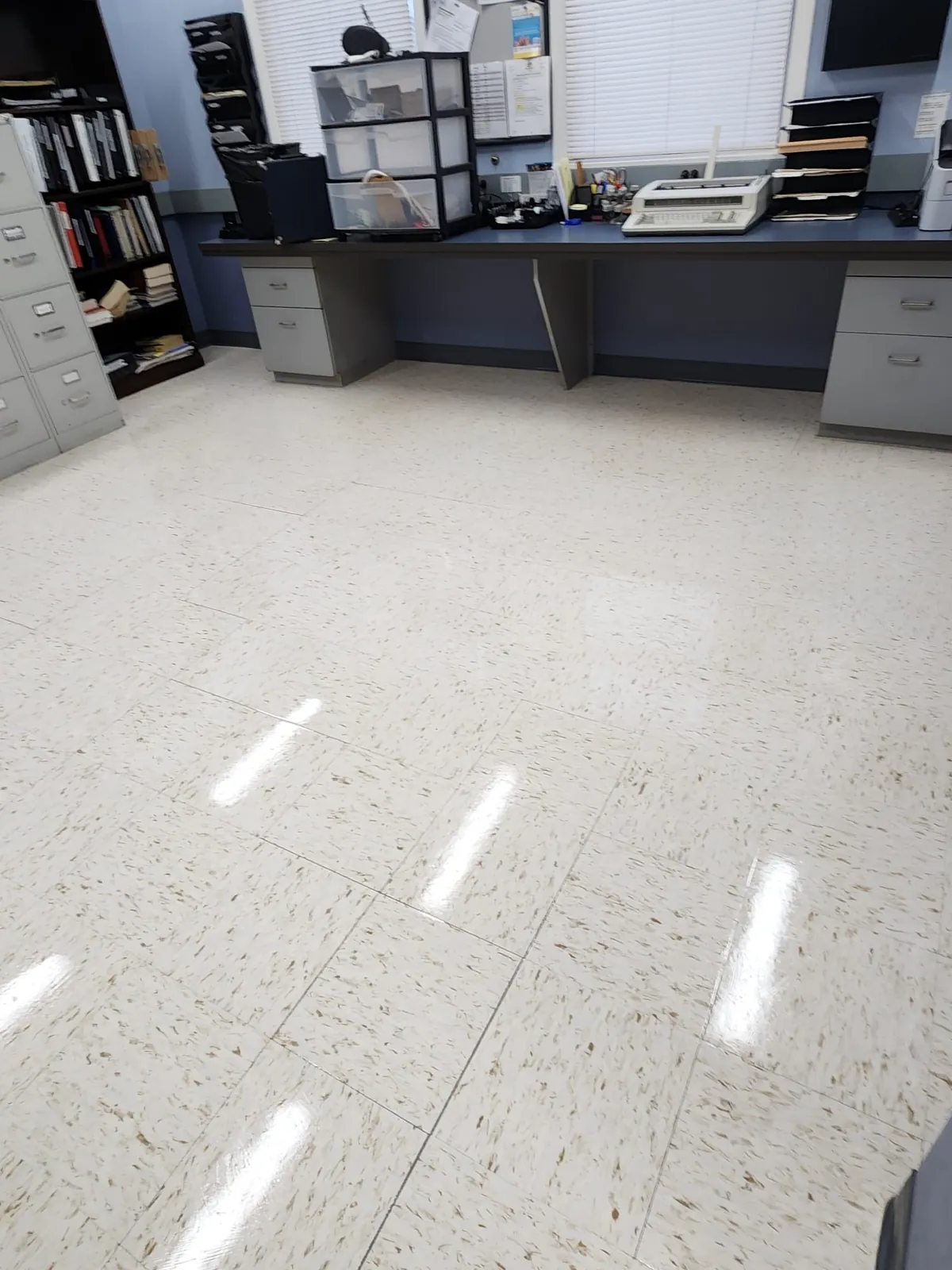 Same common-area floor after cleaning, glossy and reflective