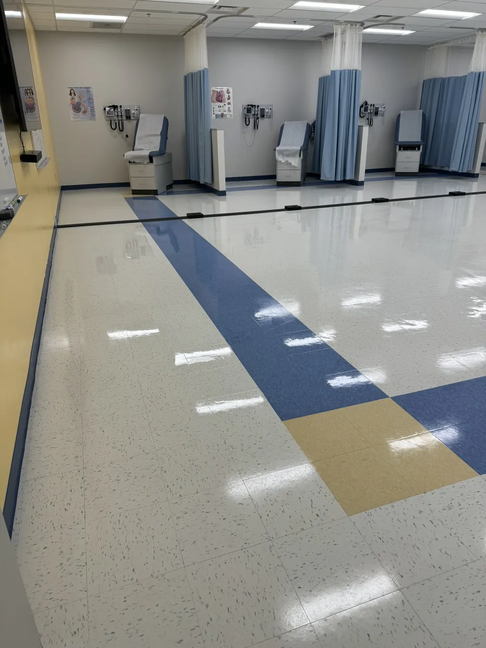 Polished medical exam-area floor with a clean reflective shine, maintained by SparkClean