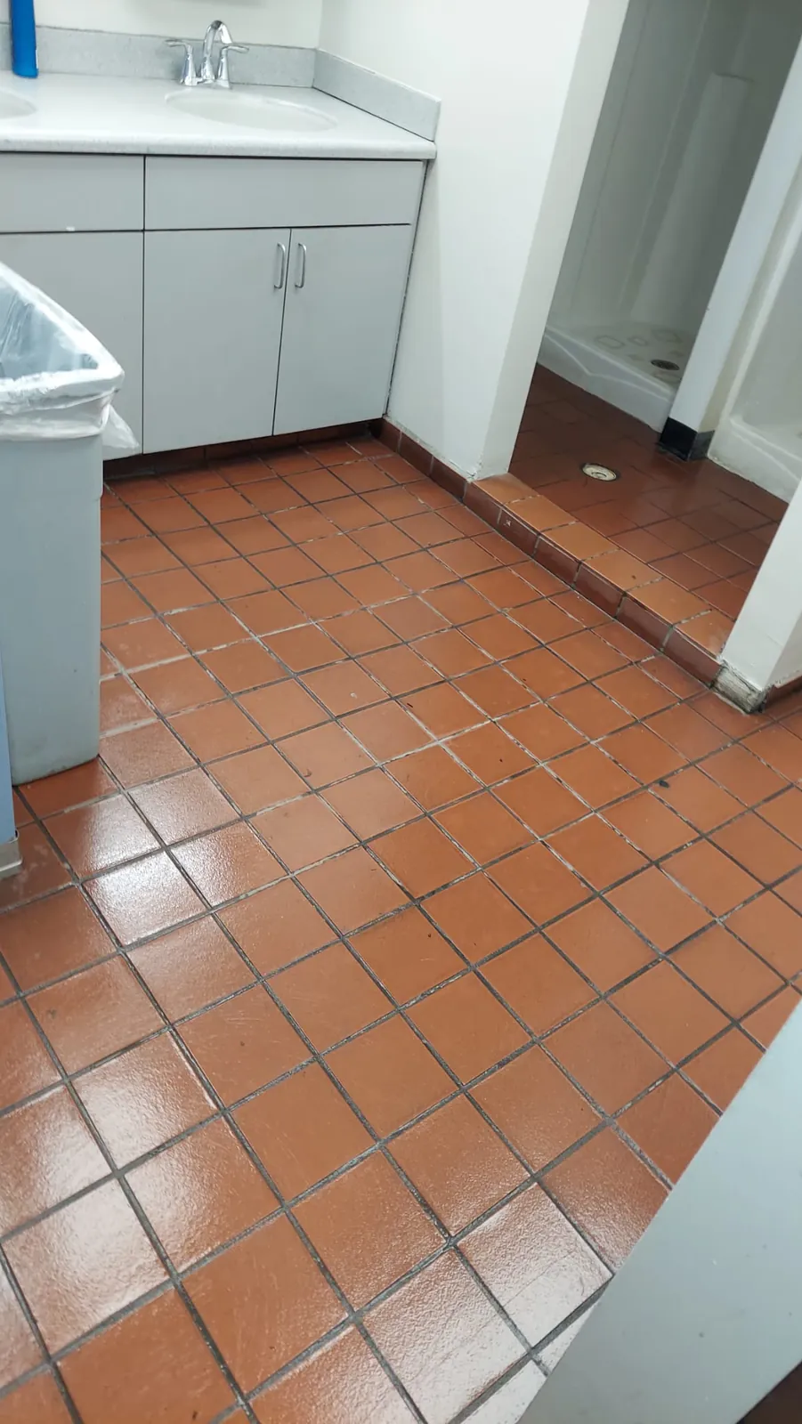 Finished red tile floor with a clean reflective shine