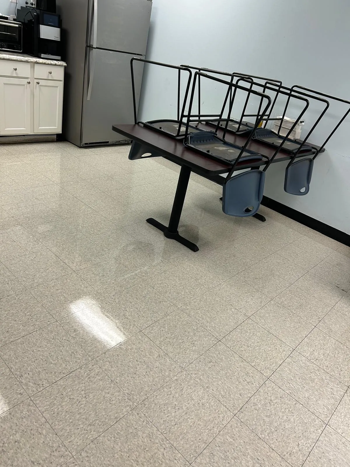 Clean room floor with stacked chairs and a polished finish