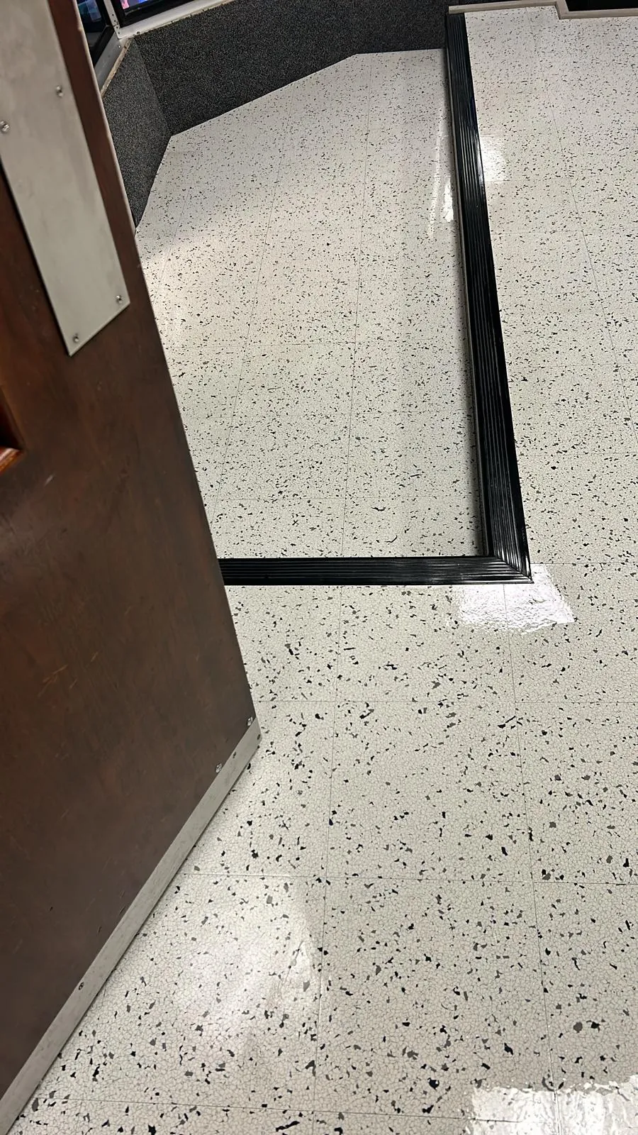 Clean threshold floor detail with a reflective finish