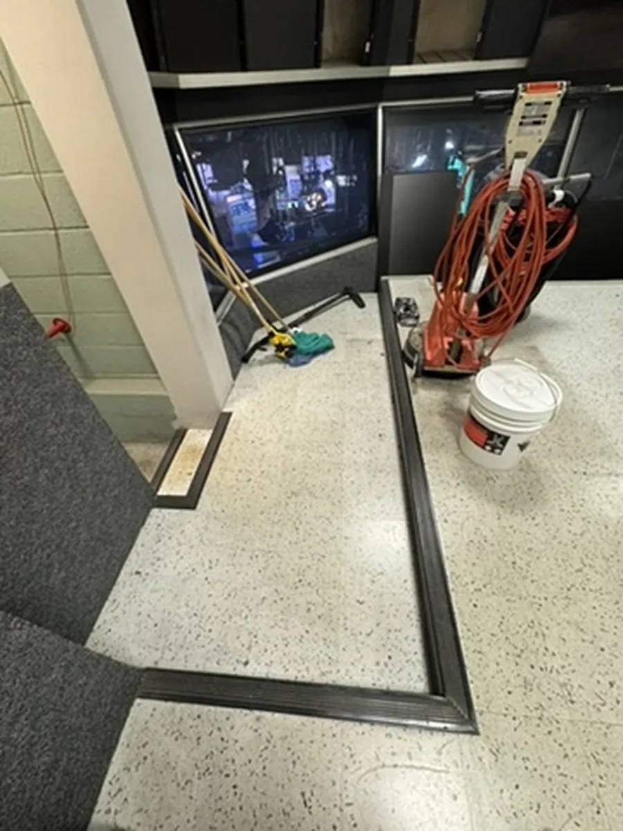 Office tile floor before cleaning, with ground-in soil and marks